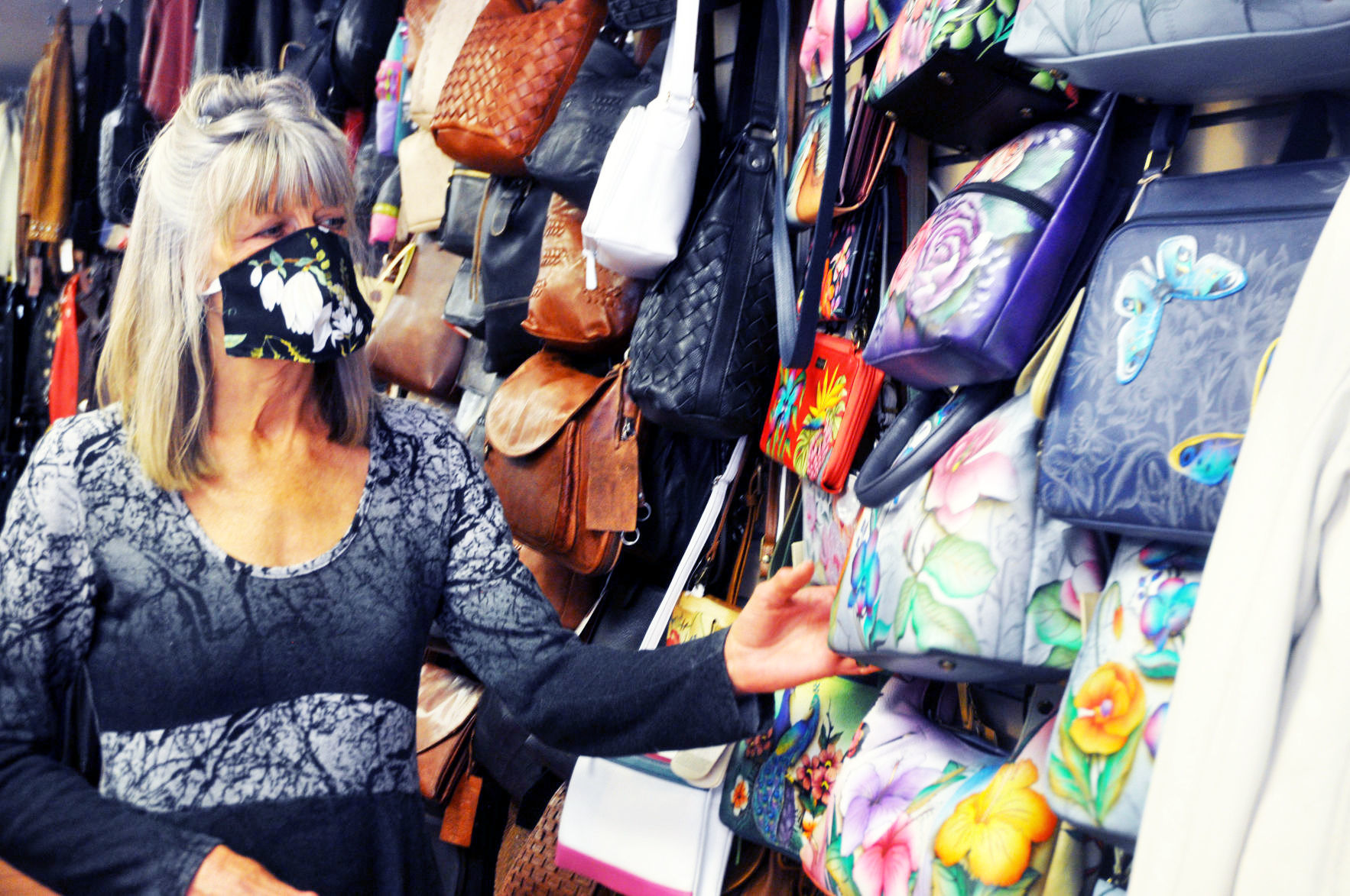 Leather Accents owner Linda Longwell wears face mask